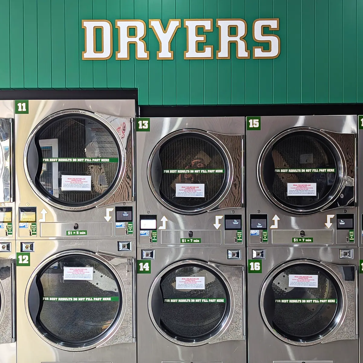 Two rows of stacked dryers under the DRYERS sign