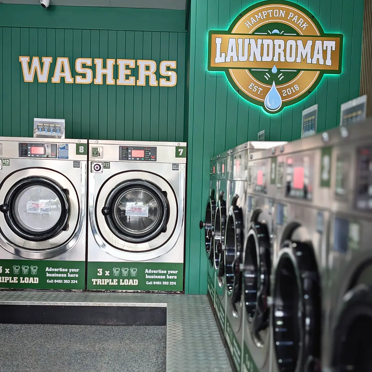Large triple-load washers under the WASHERS sign